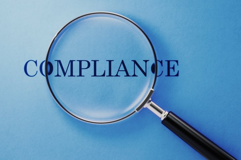 "Compliance" written on a blue background.