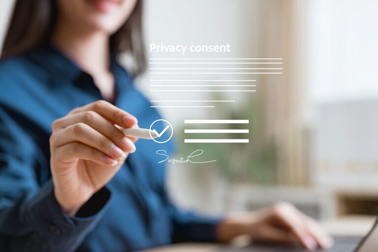 A woman in a blue shirt signs in mid-air, where a digital illustration of a contract with the words "privacy consent" suggests the issue of online security.