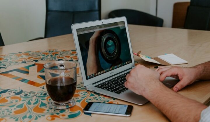Creative professional working on a digital art portfolio at home, representing building a creative portfolio and using creative self-promotion tips to market yourself as a creative online.