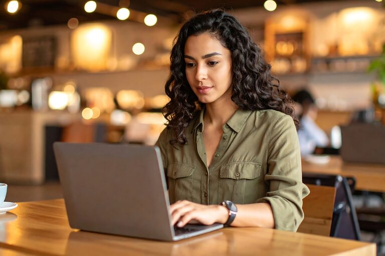 Brunette woman working on a laptop. The image illustrates the article: "How to improve Core Web Vitals in WordPress."