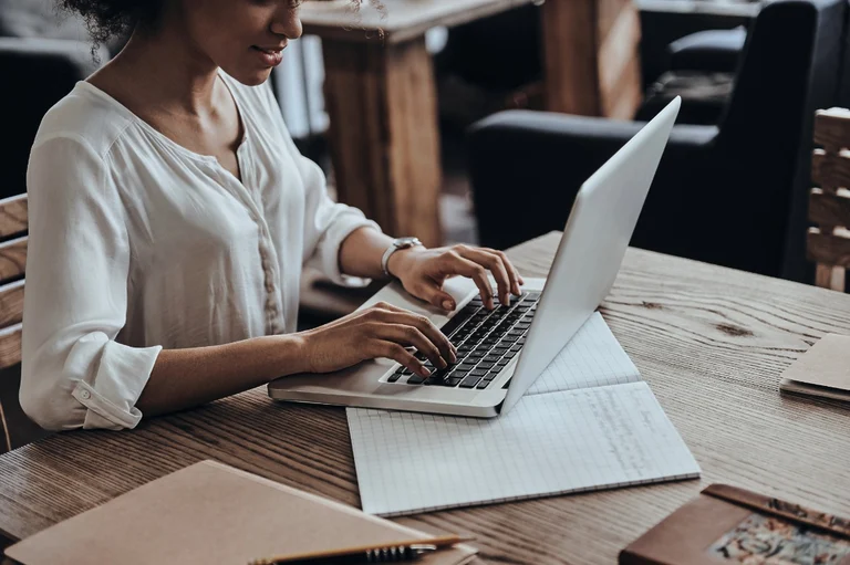 Black woman working on a laptop.