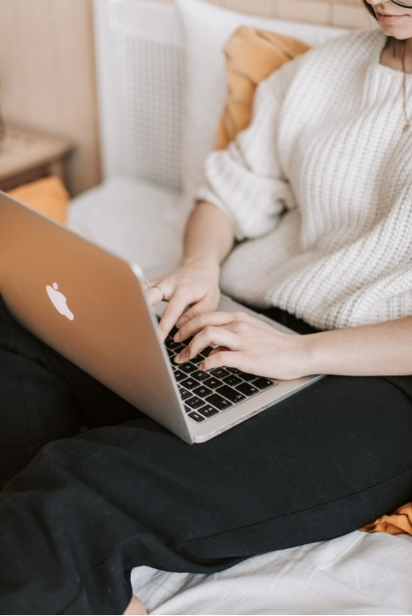 Woman writing blogs on her laptop