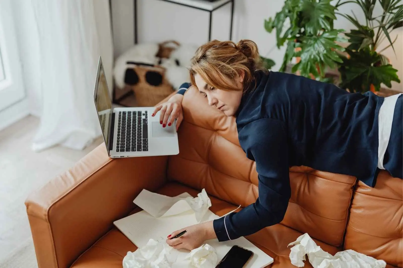 Bored woman multitasking in her home office