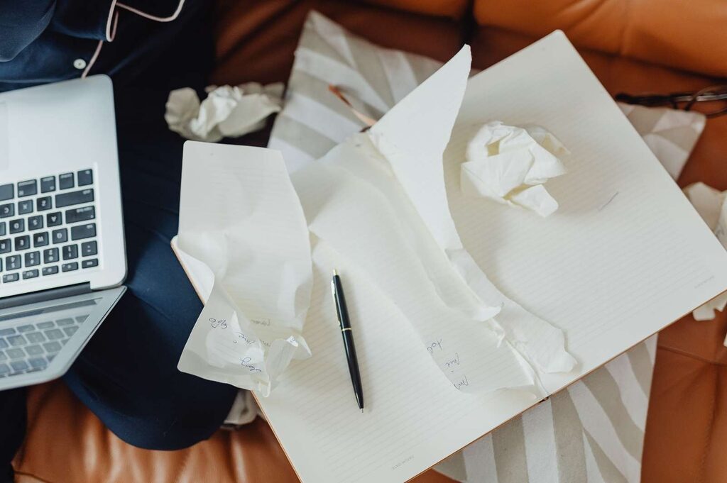 Open notebook with torn and crumpled pages.