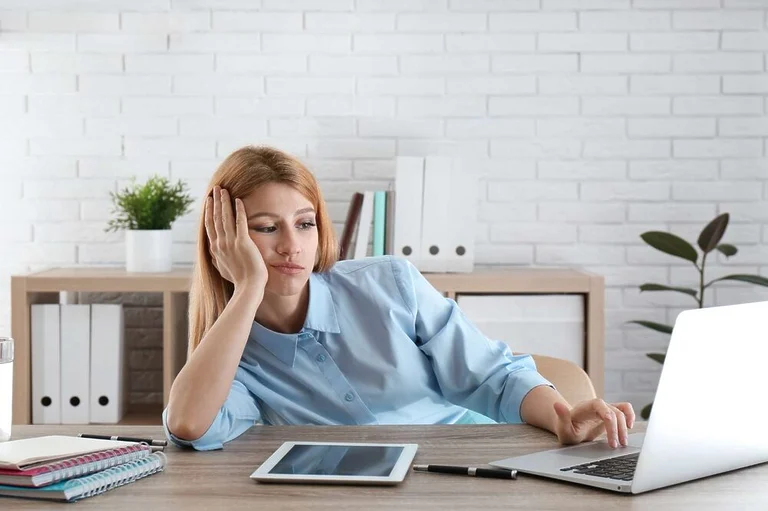 Woman looking tired and unmotivated to keep working.