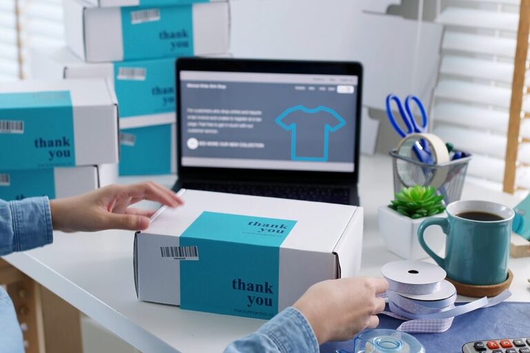 Several packages are being sealed on a table.